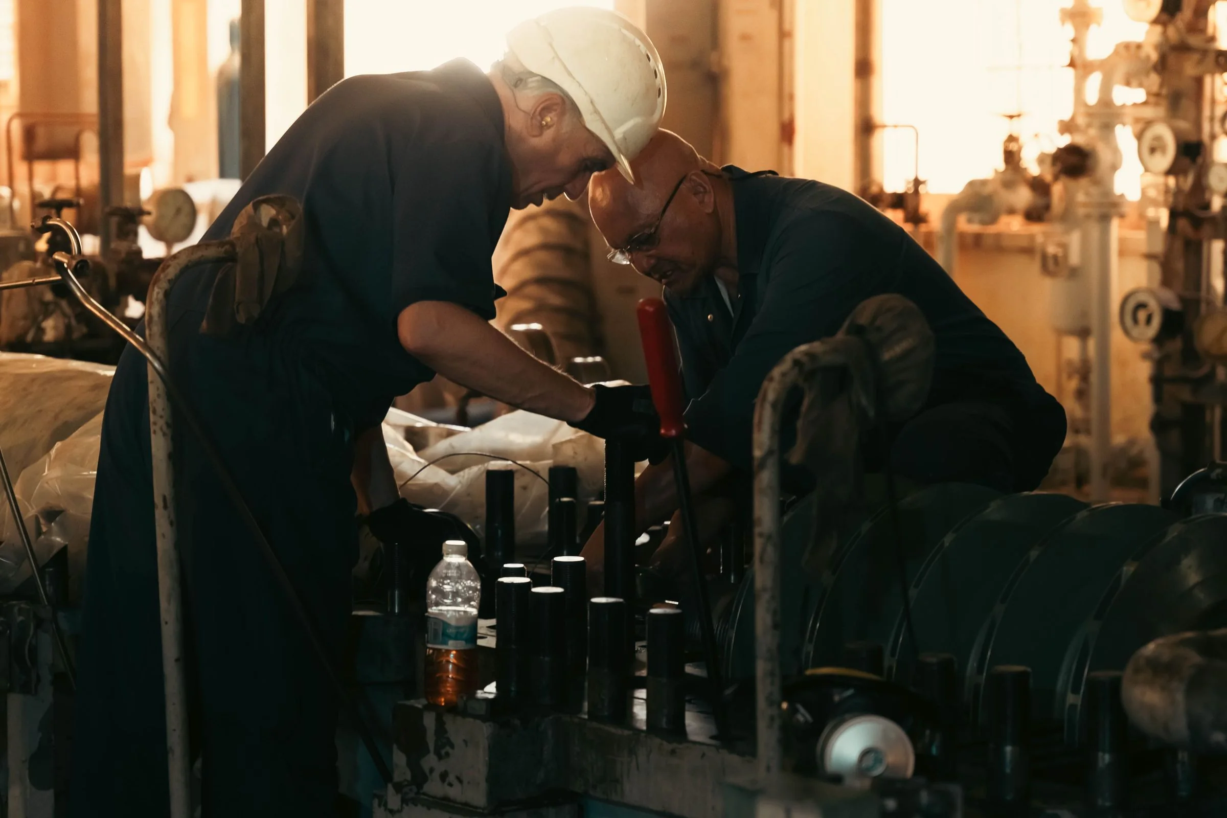 Engineers carrying out maintenance on industrial plant machinery